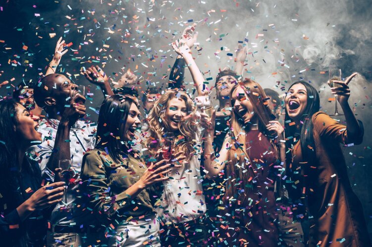 fun_motion_group_beautiful_young_people_throwing_colorful_confetti_while_dancing_looking_happy